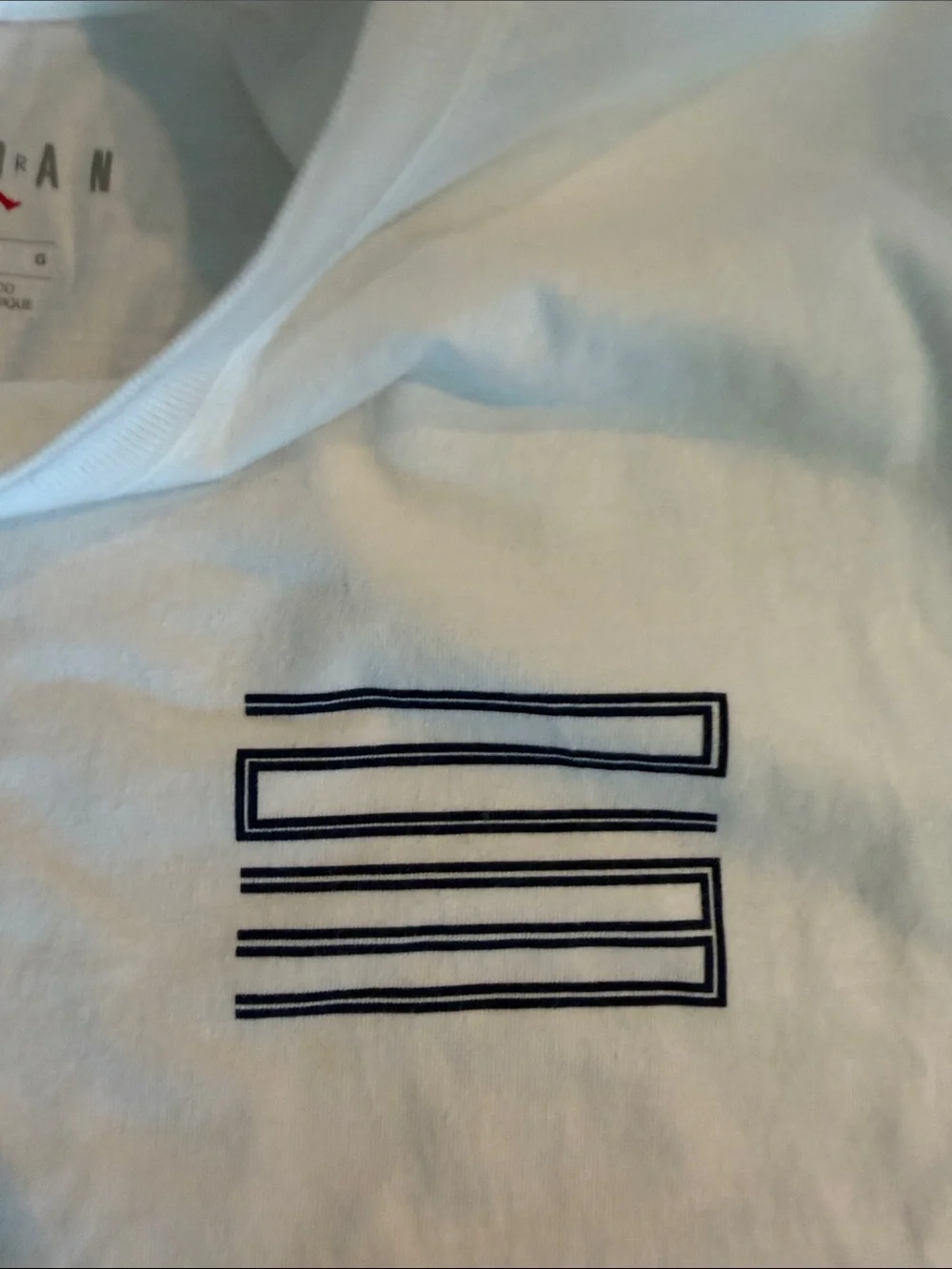 Jordan White Short Sleeve Tee with Black Graphic 'X' and Chest Stripes